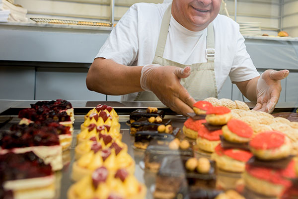 Pastry chef with cakes